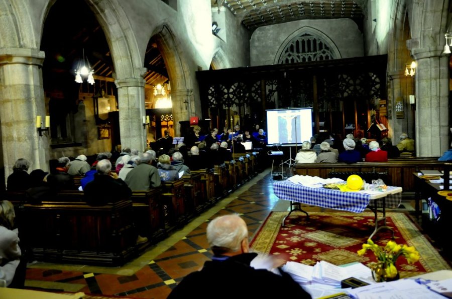 View of audience and singing group during 'Silent, Surrendered'