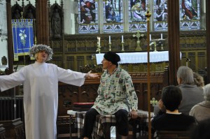 Joseph is sitting on his bed listening to the Angel of the Lord telling him that his fiancee is going to have a baby