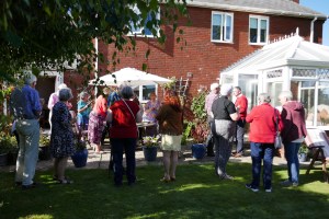 People having pre-dinner drinks and canapes in the garden