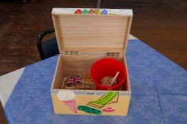 Seaside Holiday Memory Box open and showing contents, including bucket, flags and I-Spy book.